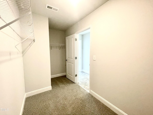walk in closet with carpet floors and visible vents