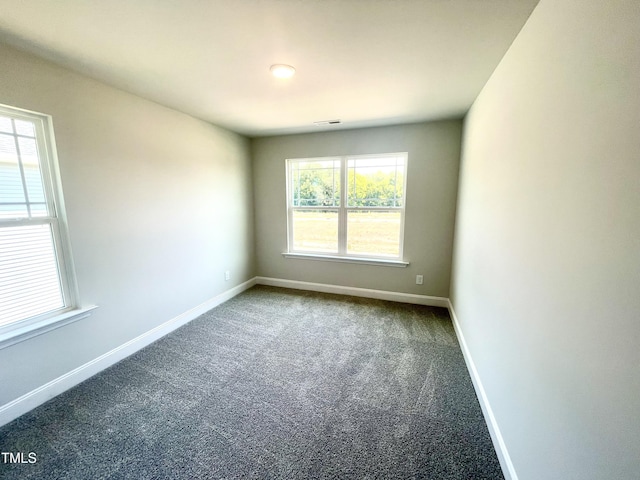 spare room with visible vents, baseboards, and carpet floors