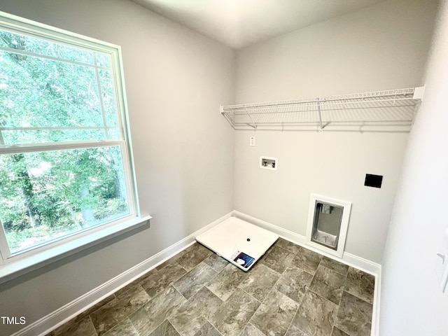 washroom with baseboards, plenty of natural light, hookup for a washing machine, and laundry area
