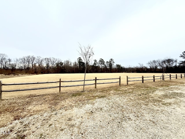 view of yard featuring a rural view and fence