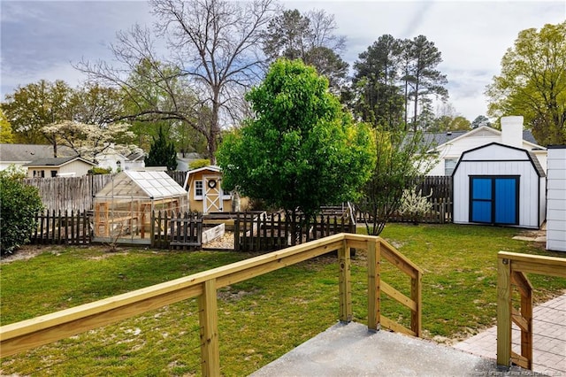 view of yard with a storage unit, a fenced backyard, an outbuilding, and an exterior structure