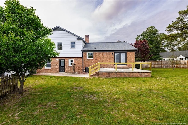 back of property featuring french doors, a fenced backyard, a lawn, and a patio area