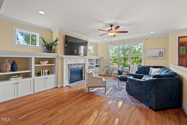 997 Windy Rd, Apex, NC 27502 - living room featuring light wood-type flooring, ceiling fan, a fireplace, crown molding, and recessed lighting