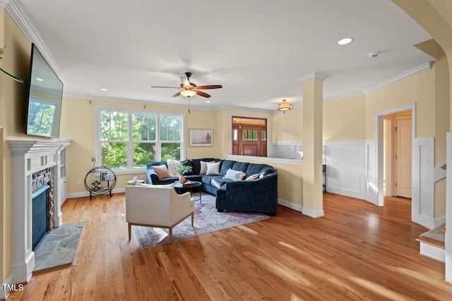 997 Windy Rd, Apex, NC 27502 - living area featuring ornamental molding, a fireplace with flush hearth, a ceiling fan, light wood-style floors, and recessed lighting