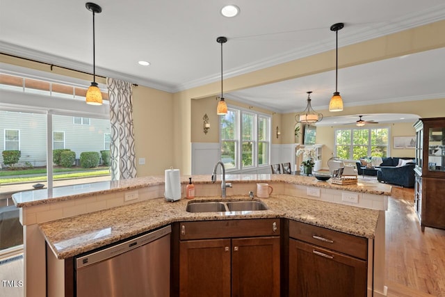 997 Windy Rd, Apex, NC 27502 - kitchen featuring stainless steel dishwasher, open floor plan, ceiling fan, plenty of natural light, and crown molding