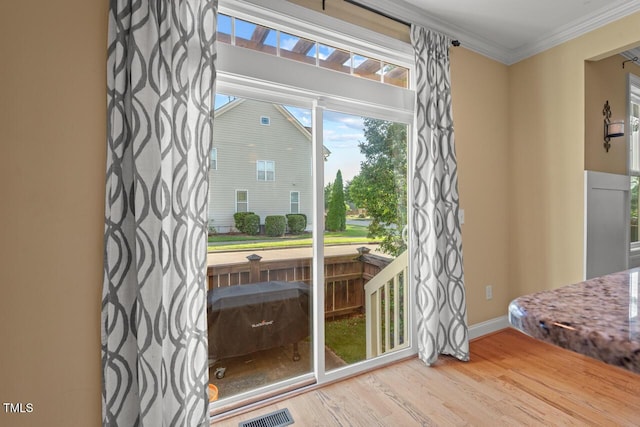 997 Windy Rd, Apex, NC 27502 - doorway to outside featuring ornamental molding and wood finished floors