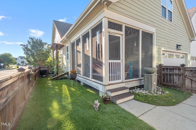 997 Windy Rd, Apex, NC 27502 - view of side of home with a sunroom and a fenced backyard