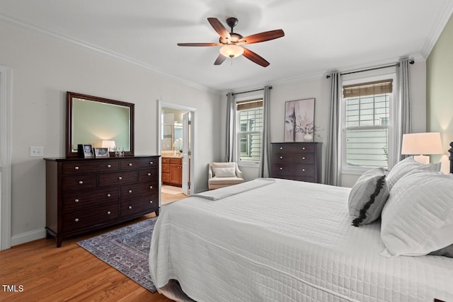 997 Windy Rd, Apex, NC 27502 - bedroom with crown molding, multiple windows, light wood finished floors, ceiling fan, and connected bathroom