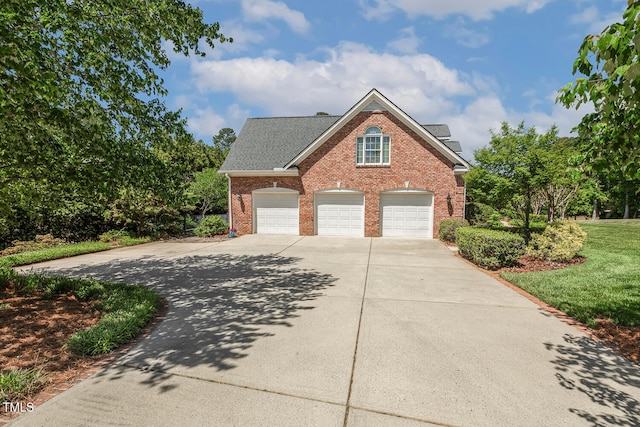 129 Trellingwood Dr, Morrisville, NC 27560 - view of front of property featuring brick siding, a garage, driveway, and a shingled roof
