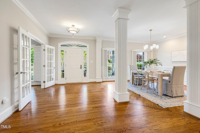 129 Trellingwood Dr, Morrisville, NC 27560 - entrance foyer featuring decorative columns, wood finished floors, crown molding, baseboards, and a chandelier