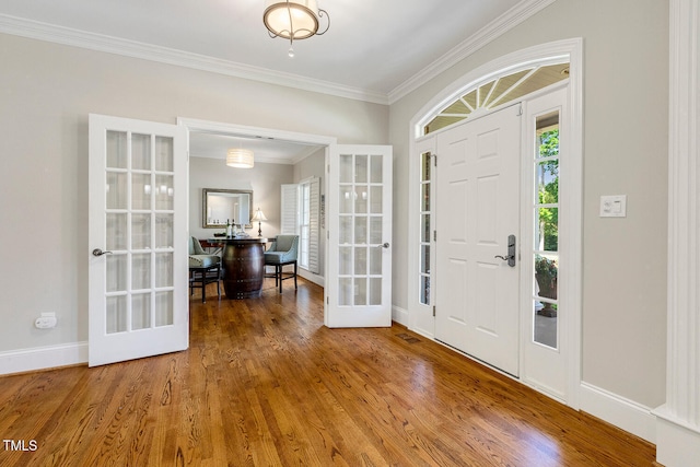 129 Trellingwood Dr, Morrisville, NC 27560 - entrance foyer featuring french doors, ornamental molding, wood finished floors, and baseboards