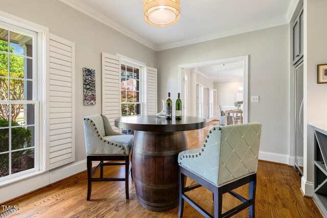 129 Trellingwood Dr, Morrisville, NC 27560 - dining space featuring wood finished floors, crown molding, and baseboards