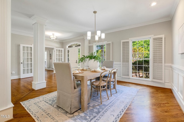 129 Trellingwood Dr, Morrisville, NC 27560 - dining area featuring ornate columns, wainscoting, ornamental molding, and wood finished floors