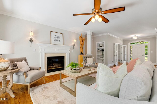 129 Trellingwood Dr, Morrisville, NC 27560 - living area with wood finished floors, ornamental molding, ceiling fan, a fireplace with flush hearth, and baseboards