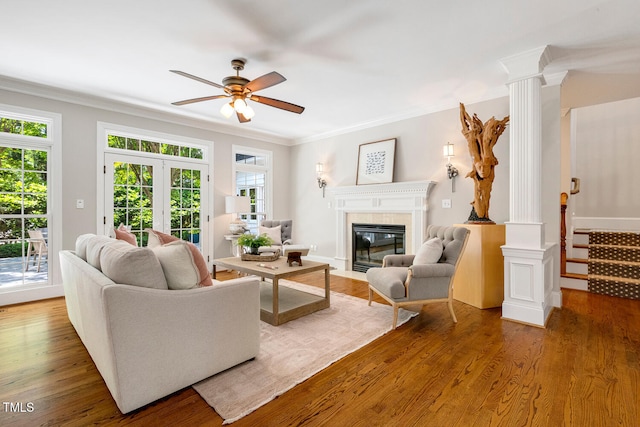 129 Trellingwood Dr, Morrisville, NC 27560 - living area featuring decorative columns, crown molding, ceiling fan, wood finished floors, and a fireplace with flush hearth