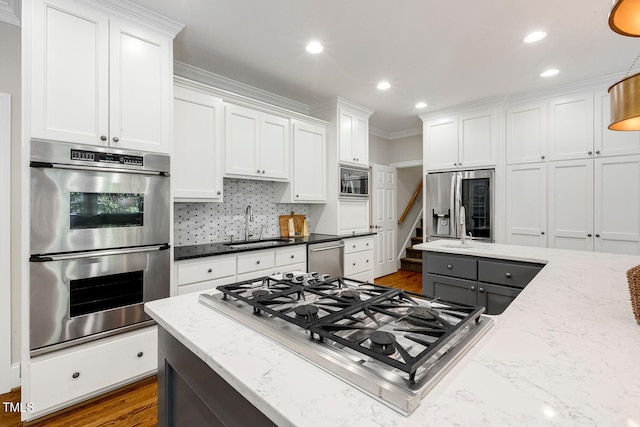 129 Trellingwood Dr, Morrisville, NC 27560 - kitchen featuring stainless steel appliances, a sink, white cabinets, recessed lighting, and crown molding