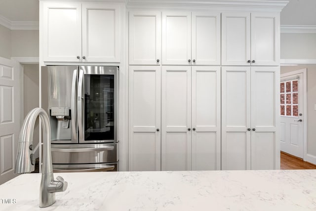 129 Trellingwood Dr, Morrisville, NC 27560 - kitchen featuring stainless steel fridge with ice dispenser, crown molding, light stone counters, white cabinetry, and wood finished floors