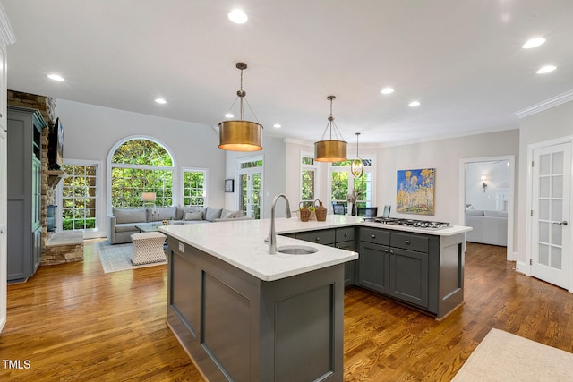 129 Trellingwood Dr, Morrisville, NC 27560 - kitchen with a sink, gray cabinetry, open floor plan, a center island with sink, and recessed lighting