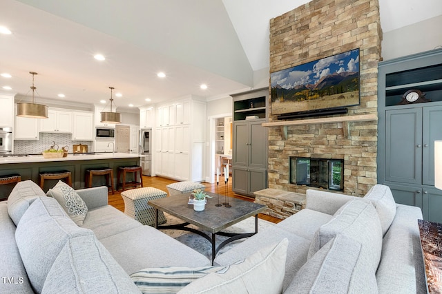 129 Trellingwood Dr, Morrisville, NC 27560 - living area featuring recessed lighting, a stone fireplace, light wood finished floors, and vaulted ceiling
