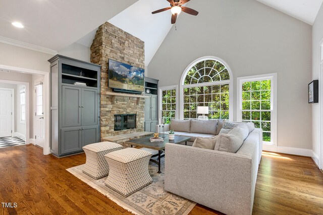 129 Trellingwood Dr, Morrisville, NC 27560 - living area with a fireplace, ceiling fan, wood finished floors, high vaulted ceiling, and baseboards
