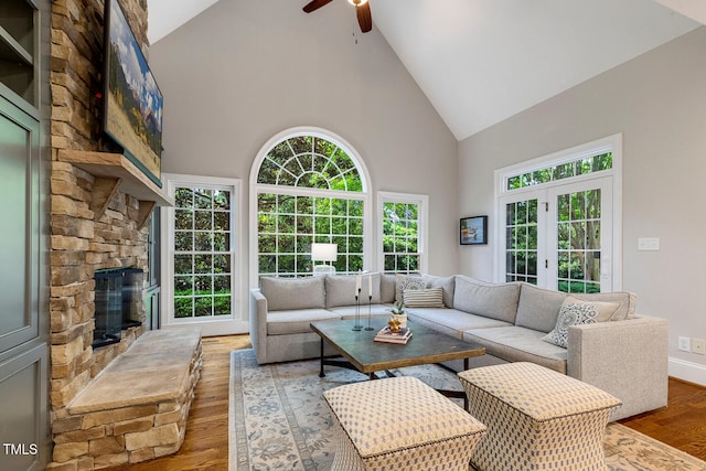 129 Trellingwood Dr, Morrisville, NC 27560 - living area with high vaulted ceiling, ceiling fan, wood finished floors, and a fireplace