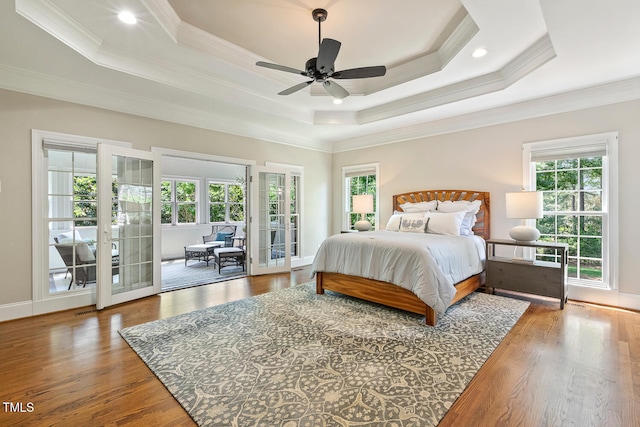 129 Trellingwood Dr, Morrisville, NC 27560 - bedroom featuring access to outside, ornamental molding, a raised ceiling, wood finished floors, and french doors