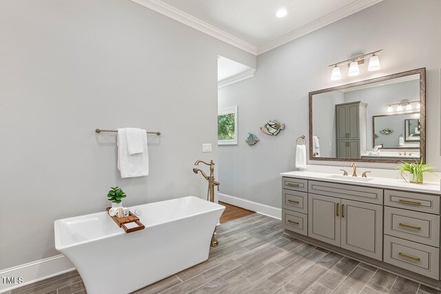 129 Trellingwood Dr, Morrisville, NC 27560 - bathroom with a freestanding tub, crown molding, baseboards, vanity, and wood finished floors