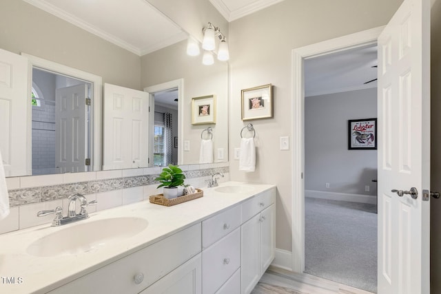129 Trellingwood Dr, Morrisville, NC 27560 - bathroom featuring crown molding, double vanity, baseboards, and wood finished floors