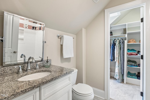 129 Trellingwood Dr, Morrisville, NC 27560 - bathroom featuring vanity, lofted ceiling, a walk in closet, and toilet