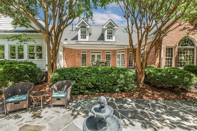 129 Trellingwood Dr, Morrisville, NC 27560 - view of front of house featuring a patio area, brick siding, and roof with shingles