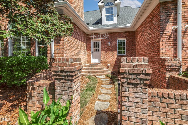 129 Trellingwood Dr, Morrisville, NC 27560 - entrance to property featuring a shingled roof and brick siding