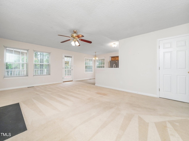 5504 Cumberland Plain Dr, Raleigh, NC 27616 - unfurnished living room featuring light carpet, baseboards, a textured ceiling, and ceiling fan