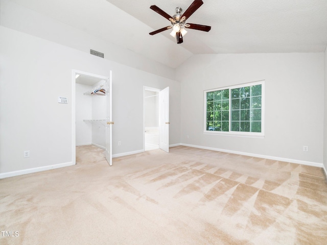 5504 Cumberland Plain Dr, Raleigh, NC 27616 - unfurnished bedroom with a walk in closet, carpet floors, baseboards, lofted ceiling, and visible vents