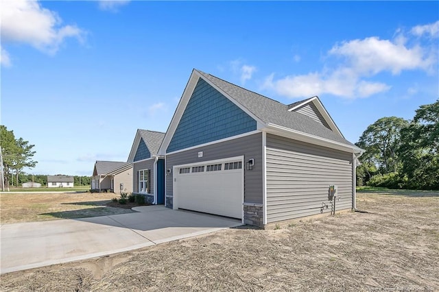 4915 High Branch Ct, Stedman, NC 28391 - view of side of property featuring driveway, an attached garage, and stone siding
