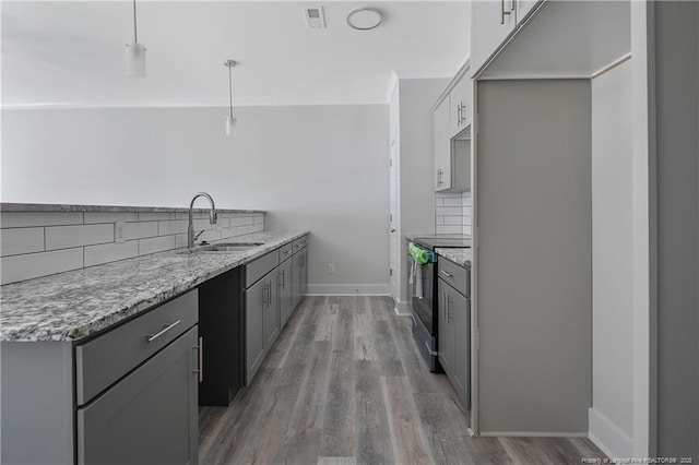4915 High Branch Ct, Stedman, NC 28391 - kitchen featuring electric stove, tasteful backsplash, light wood finished floors, and gray cabinetry