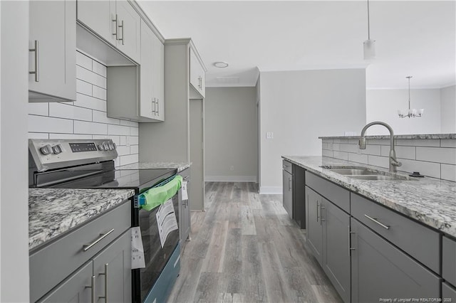 4915 High Branch Ct, Stedman, NC 28391 - kitchen with stainless steel electric range oven, gray cabinets, backsplash, light wood-type flooring, and crown molding