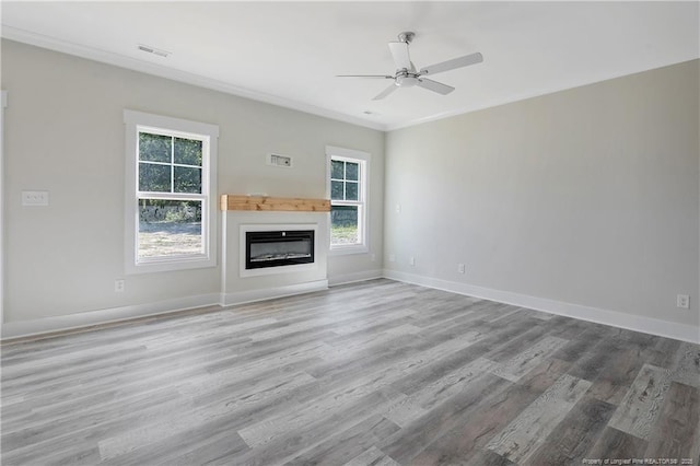 4915 High Branch Ct, Stedman, NC 28391 - unfurnished living room with a ceiling fan, wood finished floors, a glass covered fireplace, and crown molding