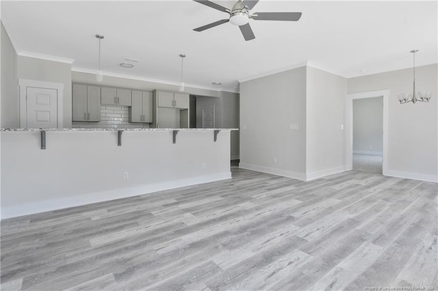 4915 High Branch Ct, Stedman, NC 28391 - unfurnished living room featuring ornamental molding, a ceiling fan, light wood-style flooring, and a chandelier