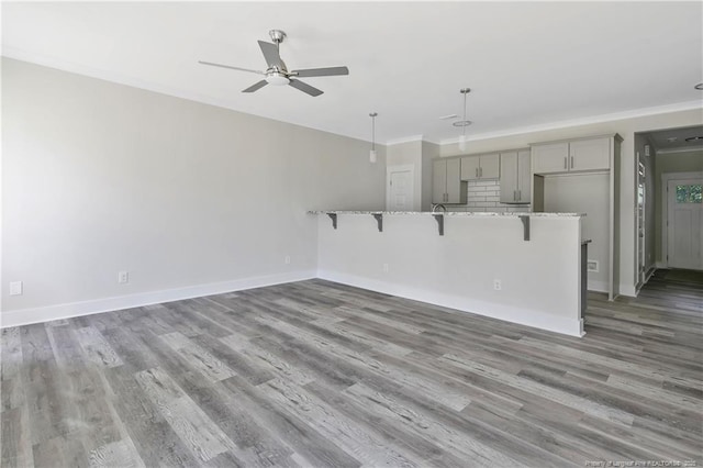 4915 High Branch Ct, Stedman, NC 28391 - unfurnished living room with a ceiling fan, wood finished floors, and ornamental molding
