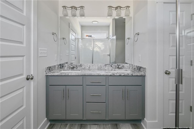 4915 High Branch Ct, Stedman, NC 28391 - full bathroom featuring double vanity, a shower stall, and wood finished floors