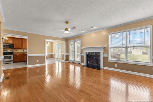 193 Wind Brook Ct, Raeford, NC 28376 - unfurnished living room featuring a fireplace, light wood-style flooring, a ceiling fan, and ornamental molding