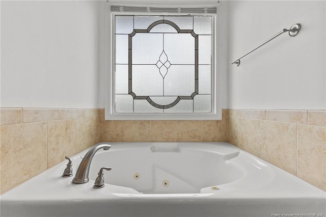 193 Wind Brook Ct, Raeford, NC 28376 - bathroom featuring a tub with jets and a wealth of natural light