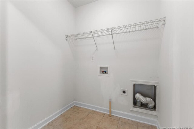 193 Wind Brook Ct, Raeford, NC 28376 - laundry area featuring electric dryer hookup, laundry area, light tile patterned floors, baseboards, and hookup for a washing machine