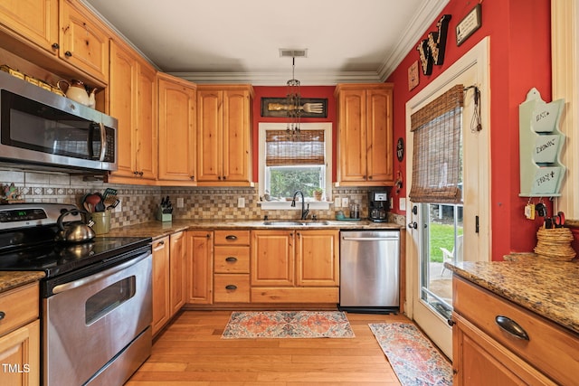 8437 Little Woody Ct, Zebulon, NC 27597 - kitchen with crown molding, a sink, light wood finished floors, tasteful backsplash, and stainless steel appliances