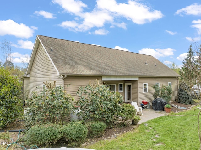 8437 Little Woody Ct, Zebulon, NC 27597 - back of property featuring a patio, a shingled roof, and a lawn