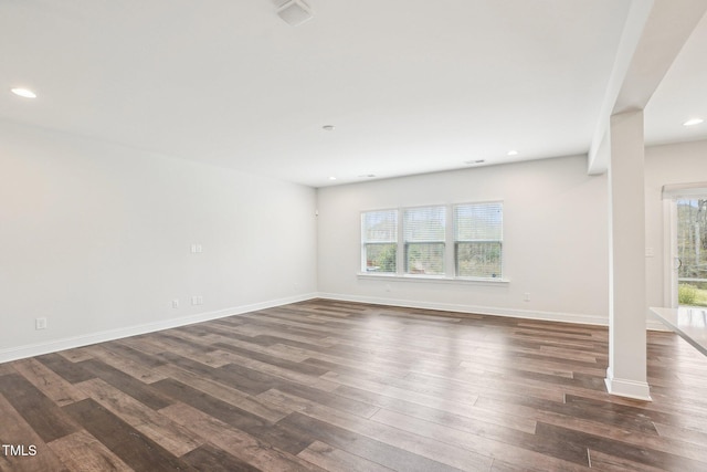 empty room with baseboards, dark wood-style floors, and recessed lighting