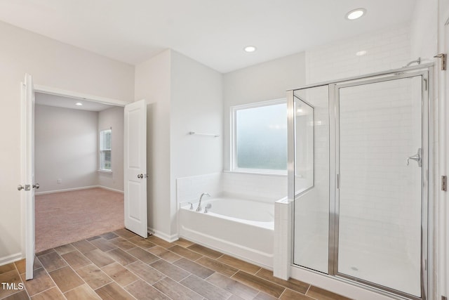 full bathroom featuring a shower stall, baseboards, recessed lighting, and a bath