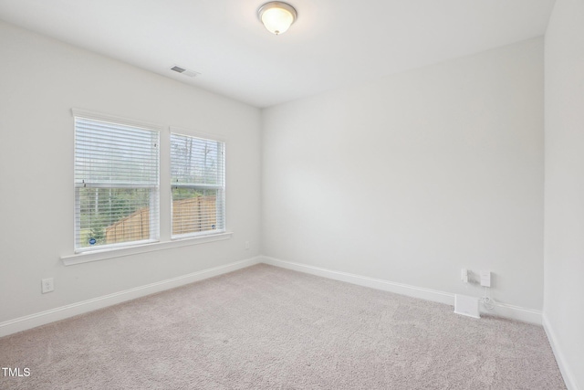 carpeted empty room with baseboards and visible vents