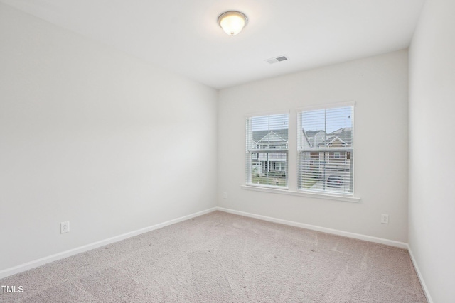 unfurnished room featuring carpet floors, baseboards, and visible vents