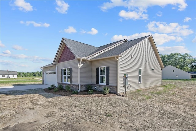 4905 High Branch Ct, Stedman, NC 28391 - view of home's exterior with an attached garage, concrete driveway, stone siding, and roof with shingles